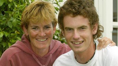Andy Murray holding his US Open boys' singles trophy, with his mother Judy, outside his home in Dunblane, Scotland, in 2004. PA