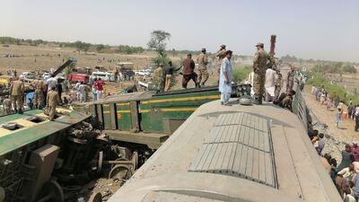Paramilitaries and rescue workers gather at the site of a train crash in Ghotki, southern Pakistan. Reuters
