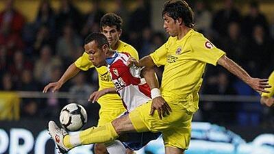 Villarreal's Joan Capdevilla, right, and Mateo Musacchio double team Sevilla's Luis Fabiano.
