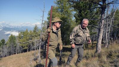 Russian President Vladimir Putin (L) enjoys a walk during his leisure time in the Siberian Taiga area, Russia. EPA