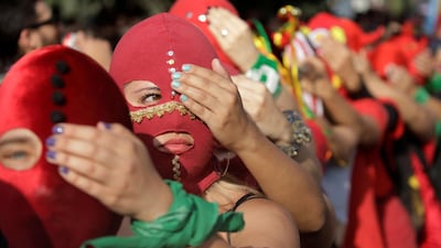 Women wearing masks take part in a protest against gender violence and the Chile's government in Santiago, Chile. Reuters