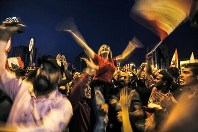 Lebanese protesters wave national flags as they attend a demonstration on the sixth day of protest against tax increases and official corruption at Nur Square in Lebanon's northern city of Tripoli. AFP
