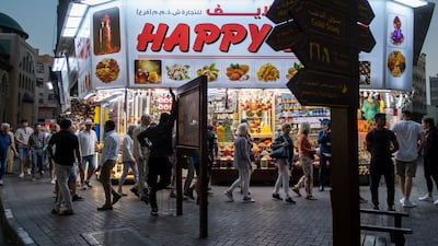 Tourists walk the streets during sunset in Ramadan in Deira.