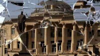 A statue of Josef Stalin is reflected in broken glass in Gori, where the threat of looting is still very high.