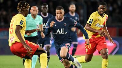 Kylian Mbappe fights for the ball with Lens defenders Christopher Wooh and Cheick Doucoure. AFP