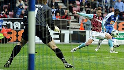 Wigan's Charles N'Zogbia, far right, scores the goal that relegated West Ham United from the Premier League yesterday.