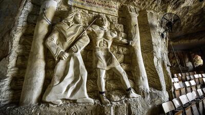 This picture taken shows a view of a relief sculpture made by Polish artist Mario at the St. Simon the Tanner Monastery complex in the Egyptian capital Cairo's eastern hillside Mokattam district, depicting the torture of the Old Testament Biblical figure Samson at the hands of the Philistines according to the Book of Judges. Mario spent more than two decades carving the rugged insides of the seven cave churches and chapels of the rock-hewn St. Simon Monastery and church complex atop Cairo's Mokattam hills, with designs inspired by biblical stories. It was all done to fulfil the wishes of the church's parish priest who met Mario in the early 1990s in Cairo. The Polish artist, who had arrived in Egypt earlier on an educational mission, was then looking for an opportunity to serve God at the monastery. AFP