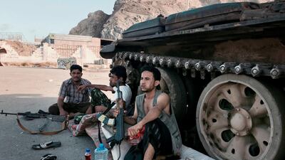 Members of a militia loyal to Yemen's President Abdrabu Mansur Hadi sit next to their tank at a major intersection in Aden. AP, File