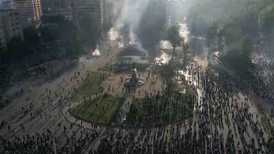 In this aerial view demonstrators clash with riot police at Plaza Baquedano, Santiago. Chile. AFP