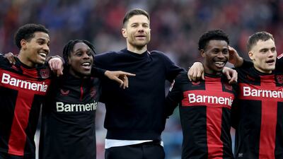 Xabi Alonso, centre, head coach of Bayer Leverkusen, has his unbeaten team on course for a historic treble. Getty Images