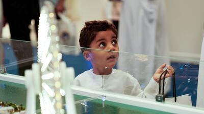 A child checks out a display at the boat show.