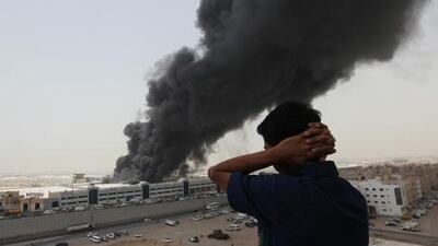 Thick smoke billows from the burning National Paints Factory in Al Dhaid road, Al Sharjah.