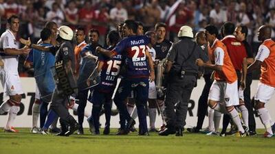 Security officials step in after Sao Paulo and Tigre players are involved in a fight at half time in the Copa Sudamericana final.