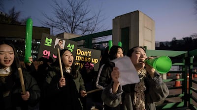Students gather to cheer on others outside the Ehwa Girls Foreign Language High School in Seoul, South Korea. AFP