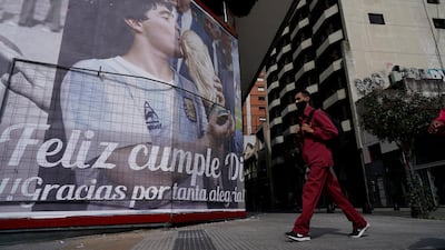 A billboard shows photos of Maradona and the Spanish message: "Happy Birthday Diego, thank you for so much happiness" in Buenos Aires. AP