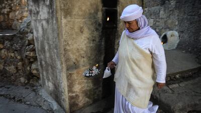 An Iraqi Yazidi woman visits the Temple of Lalish, in a valley near the Kurdish city of Dohuk about 430km northwest of the capital Baghdad, on July 16, 2019. AFP