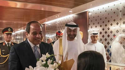 Abdel Fattah El Sisi, President of Egypt, is presented with flowers upon his arrival at the Presidential Airport. Seen with Sheikh Mohamed bin Zayed, Crown Prince of Abu Dhabi and Deputy Supreme Commander of the Armed Forces. Hamad Al Kaabi / Ministry of Presidential Affairs