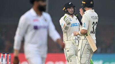 New Zealand's Tom Latham (C) is congratulated by teammate Will Young (R) after he scored a half-century (50 runs) on the second day of the first Test cricket match between India and New Zealand at the Green Park Stadium in Kanpur on November 26, 2021. (Photo by Sajjad HUSSAIN / AFP) / IMAGE RESTRICTED TO EDITORIAL USE - STRICTLY NO COMMERCIAL USE