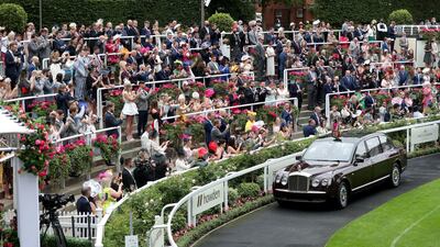Crowds cheer and clap as Queen Elizabeth II arrives by car on day five of Royal Ascot at Ascot Racecourse. PA Images