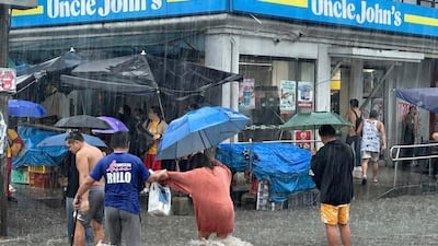 Streets flood from monsoon rains worsened by offshore Typhoon Gaemi. AP