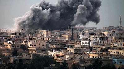 Smoke billows following reported air strikes on a rebel-held area in Daraa. Mohamad Abazeed / AFP