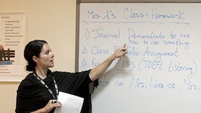 An instructor points to homework assignments for high school students taking the Summer Outreach Programme to help them to prepare for college at the American University of Sharjah. Jeff Topping/The National