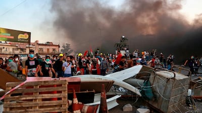 Anti-government protests set fire and close streets in Baghdad. AP Photo