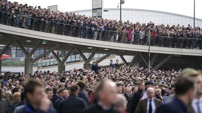 Crowds gather around the parade ring. PA