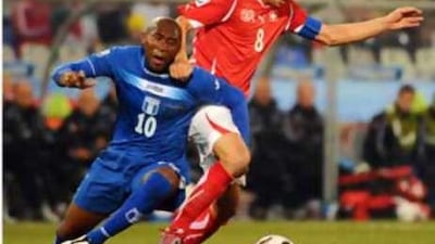 Honduras' midfielder Jerry Palacios, left, fights for the ball with Switzerland's midfielder Goekhan Inler during the Group H game.