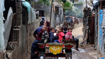 Members of a Palestinian family in Beit Lahia, in the northern Gaza Strip, on December 23. AFP