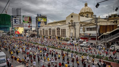 Devotees observe social distancing as they hear mass outside Quiapo church to celebrate the Feast of the Black Nazarene in Manila, Philippines. Getty