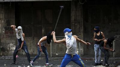 Palestinian stone throwers clash with Israeli soldiers in the West Bank city of Hebron on October 4. EPA
