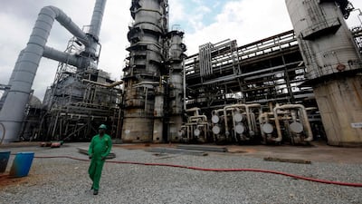 A worker walks past a refinery in Nigeria's southern oil hub, Port Harcourt. Many oil-producing nations in sub-Saharan Africa are now having to cut budgets that were set based on an average oil price of $50-$60 per barrel. AFP