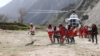 The rescue team members carry the body of a passenger of a the private jet that crashed on Sunday in the Zagros Mountains outside of the city of Shahr-e Kord. Alireza Motamedi / Tasnim News Agency via AP