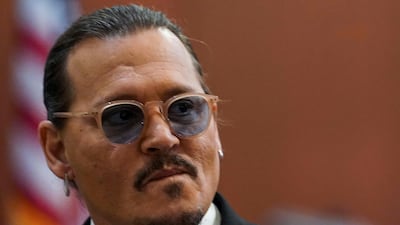 Depp looks on during a break. AFP