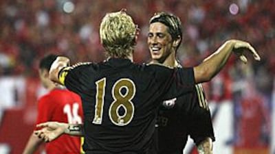 Liverpool strikers Dirk Kuyt, No 18, and Fernando Torres celebrate the fifth goal as the team win in preseason for the first time.