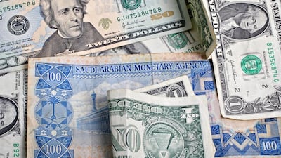 A Saudi Arabian one hundred riyal note and an assortment of US dollar bills. Stephen Hilger / Bloomberg News