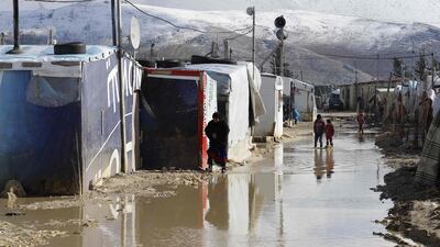 Children wade through floodwaters in Bekaa Valley, Lebanon. Joseph Eid / AFP