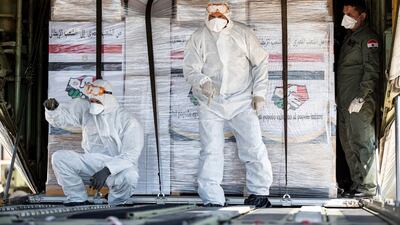 Airport staff unload medical aid sent to Italy from Egypt near Rome. EPA