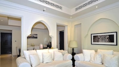 The open-plan living area includes a fully-fitted dark wood kitchen complete with white goods and a dining and living area separated by an attractive alcove. Courtesy Better Homes