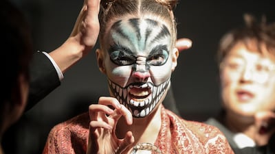 A model prepares backstage during the China Fashion Week in Beijing. Getty Images