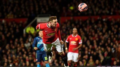 Wayne Rooney of Manchester United heads the ball to score the leveller at 1-1 on Monday night against Arsenal in the FA Cup. Laurence Griffiths / Getty Images