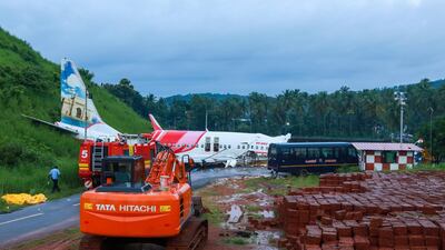 A man walks near the wreckage of an Air India Express jet at Calicut International Airport in Karipur, Kerala. AFP
