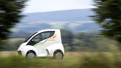 A factory worker rides an Elbee vehicle during a test drive in Lostice. David W Cerny / Reuters