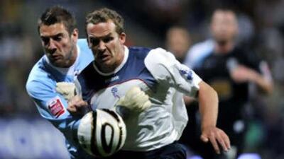 Bolton Wanderers' Kevin Davies, right, is challenged by Northampton Town's goalkeeper Mark Bunn.