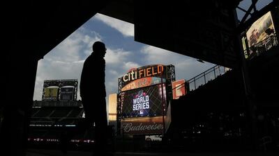 A stadium worker walks in the ball park before Game 5 of the Major League Baseball World Series between the New York Mets and Kansas City Royals Sunday, Nov. 1, 2015, in New York. (AP Photo/Charlie Riedel)