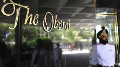 An attendant stands outside The Oberoi in Mumbai. India's luxury hotel chain is "actively looking at opportunities in Abu Dhabi". Sajjad Hussain / AFP