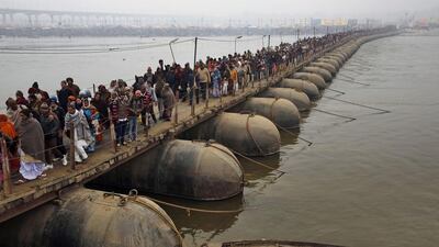 Hindu devotees walk across a pontoon bridge to arrive at the Sangam, the confluence of rivers Ganges and Yamuna, on new moon day, in Allahabad. Rajesh Kumar Singh / AP Photo