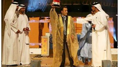 Hassan Baeiti of Syria, centre, celebrates after winning the Prince of Poets television contest last year in Abu Dhabi. The fourth season of the show kicks off with 20 contestants.