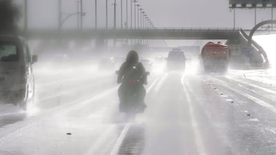 A motorbike rider braves the slippery road on the Sheikh Zayed Bin Sultan Street during rainshowers in Abu Dhbai. Victor Besa / The National